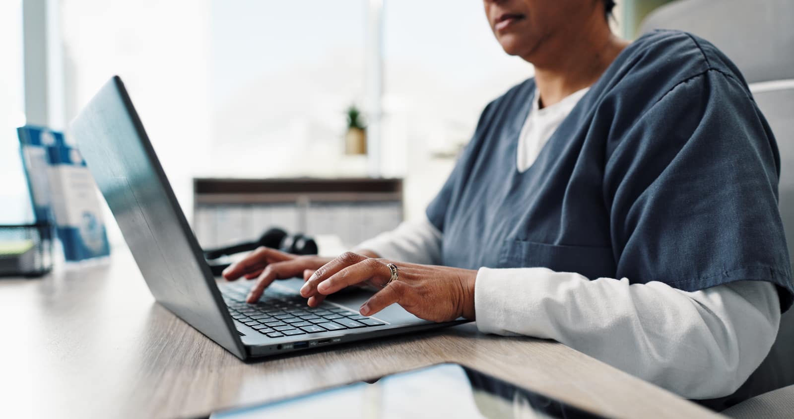 Care professional reviewing policies on a laptop