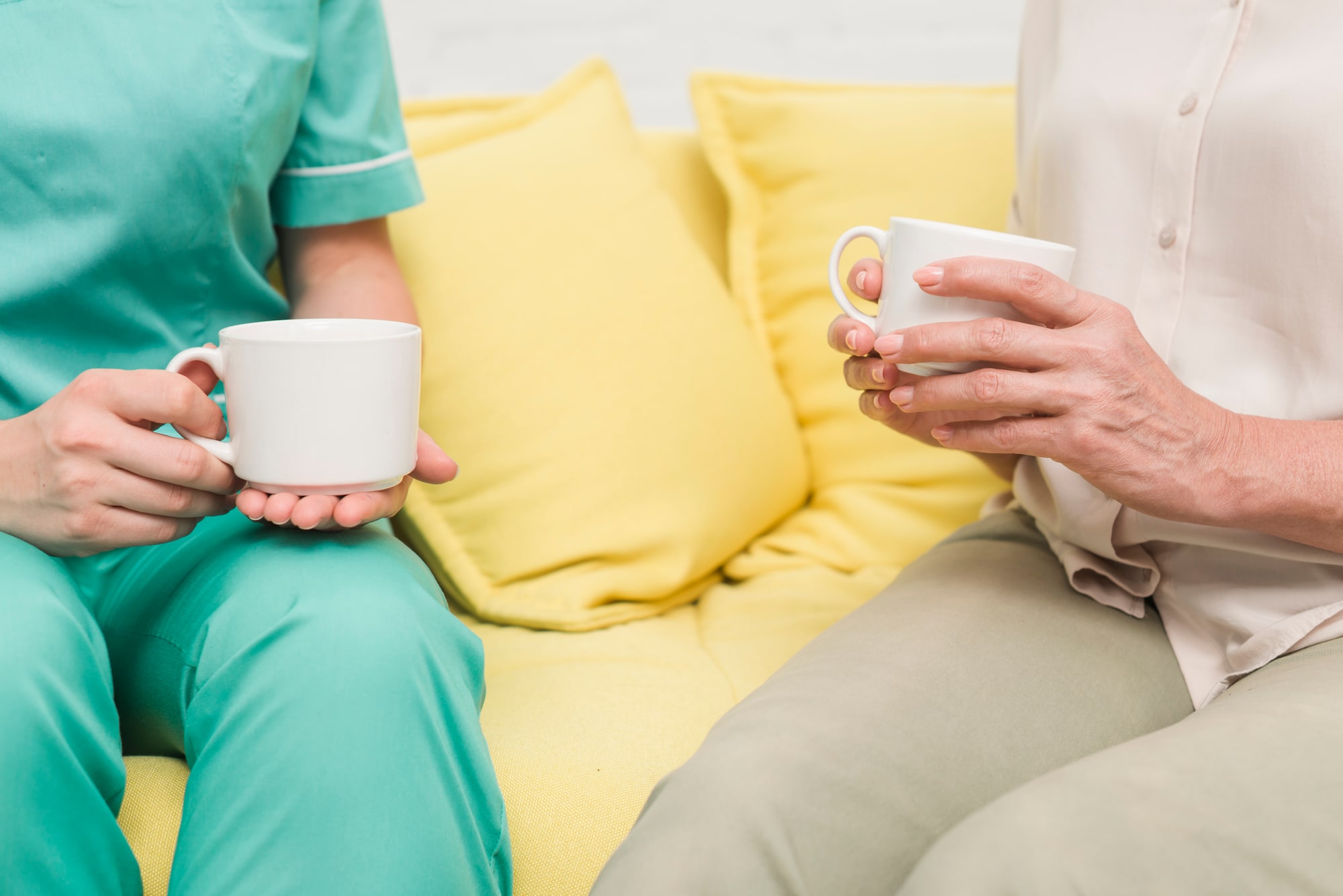 Care worker and resident sharing a coffee